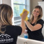 Harford 5 Star Cleaning technician cleaning a bathroom mirror
