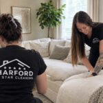 Harford 5 Star Cleaning team cleaning a living room sofa