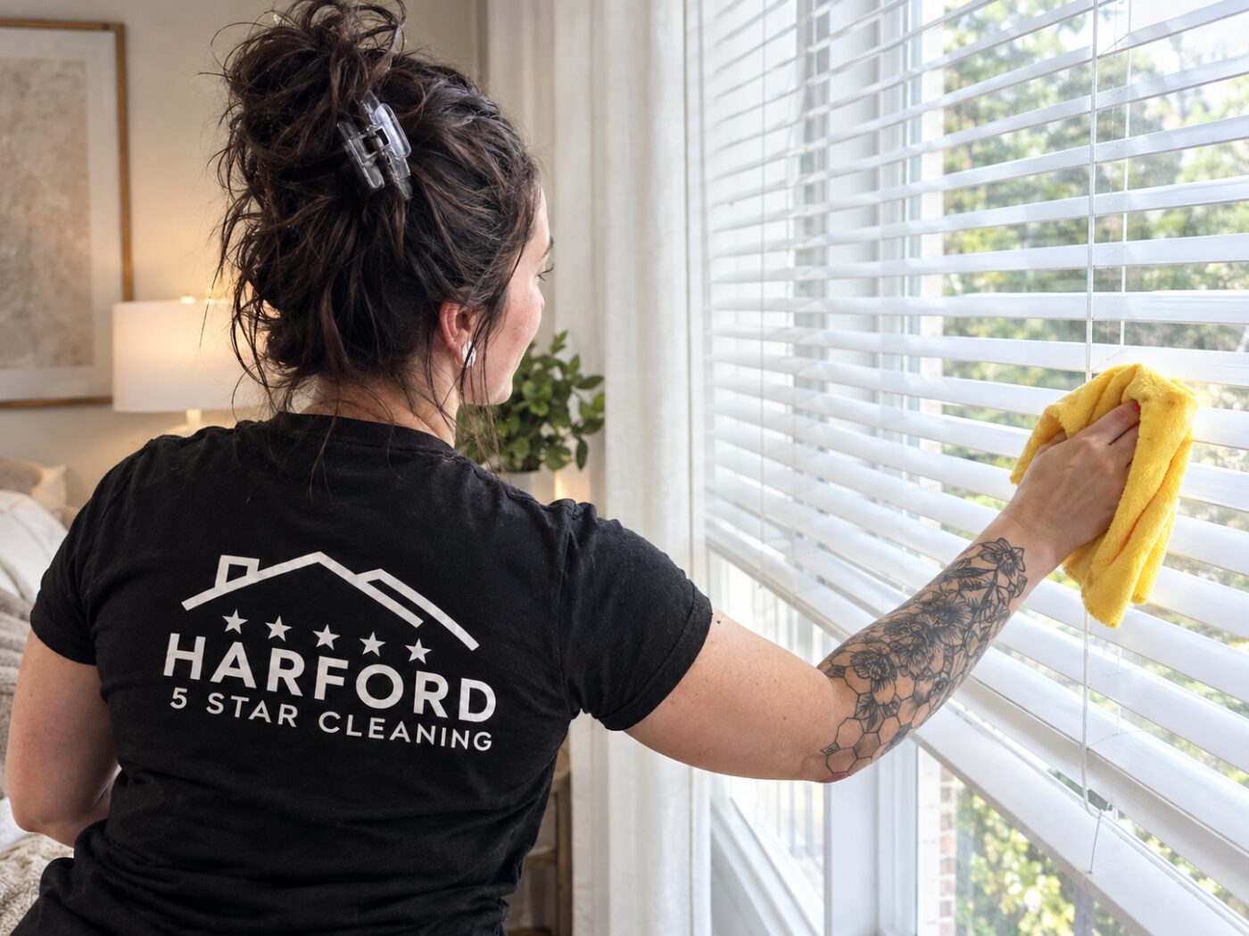 Harford 5 Star Cleaning technician wiping bedroom blinds